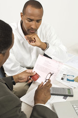 Financial advisor in discussion with businessman at desk in office