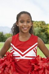 Portrait of a girl cheerleader standing on soccer field