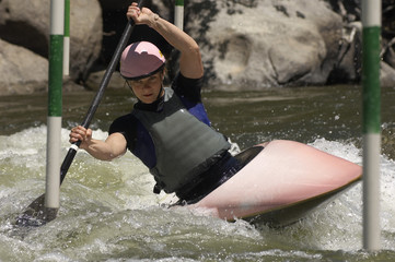 Woman struggling from a hurdle while kayaking