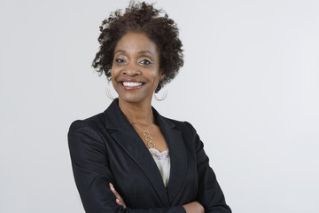 Portrait of a confident African American businesswoman with arms crossed isolated over white background