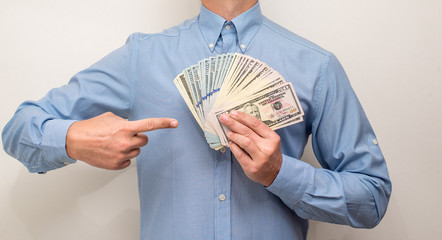 man holding a fan of the American currency 