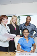 Portrait of multi ethnic business people smiling together in office