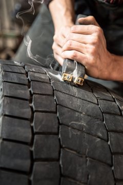 mechanic is repairing truck wheels,