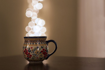 Coffee mug full of bokeh lights, Christmas theme.