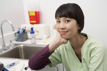 Portrait of a Asian nurse sitting in the clinic