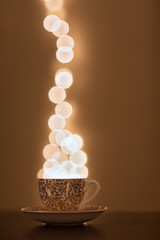 Tea cup full of bokeh lights, Christmas Theme