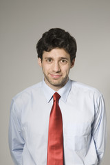 Portrait of a smiling confident businessman isolated over grey background
