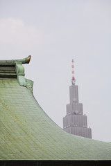 Modern Skyscraper Behind Traditional Roof of Meiji Shrine - obrazy, fototapety, plakaty
