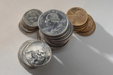 High angle view of coins stacked over grey background