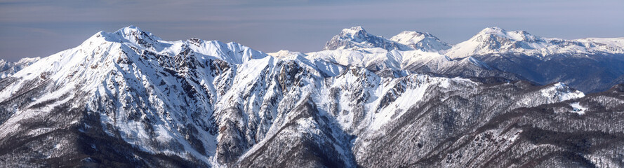 Fototapeta na wymiar Beautiful snowy mountain peaks scenic winter panoramic landscape