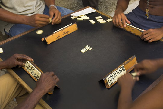 Close-up of the hands of a group of four people playing dominos in the street Centro Habana, Havana, Cuba