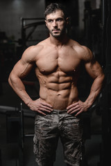 Obraz na płótnie Canvas Strong and handsome athletic young man muscles abs and biceps.