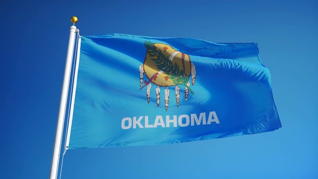 Oklahoma (U.S. state) flag waving in slow motion against blue sky, seamlessly looped, close up, isolated on alpha channel with black and white matte, perfect for film, news, composition