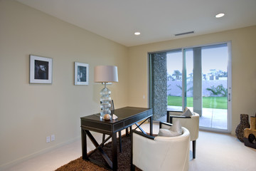 Desk and chairs in modern house interior with view of lawn