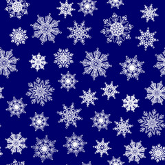 Seamless pattern, texture with white snowflakes on the dark blue background