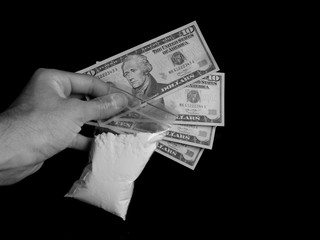 Drug dealer holding bag with cocaine drug powder and dollar bills money, men selling drugs junkie on black background in black and white colors