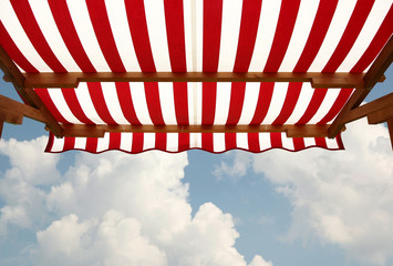 View from shade below red white striped awning