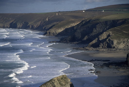 Surf and tin mine chimneys in distance, Porthtowan, Cornwall