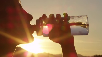 Close up portrait of cute young woman drinking fresh water from plastic bottle - Powered by Adobe