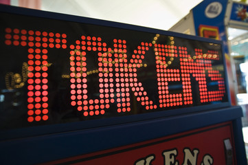 Closeup of token digital game machine at amusement park
