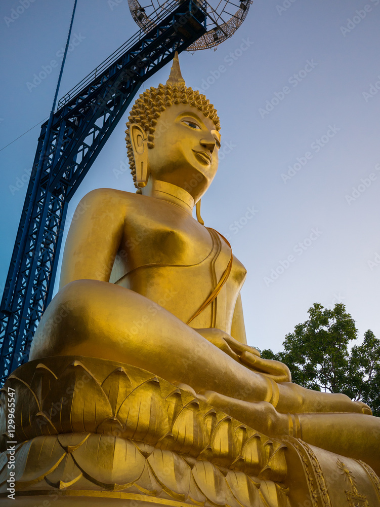 Wall mural buddha statue on a blue sky