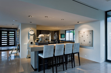 Stools at island in a modern and spacious home