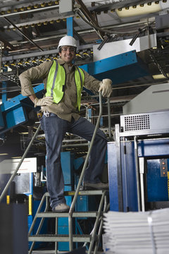 Portrait of a smiling industrial machine operator at work