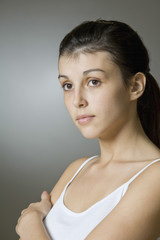 Closeup of a beautiful young woman against gray background