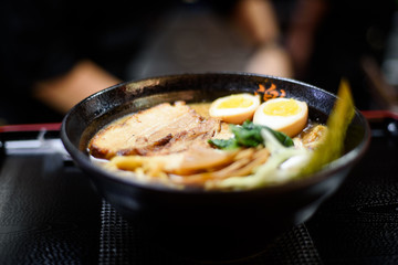 Cook geeting ready the Ramen for serving