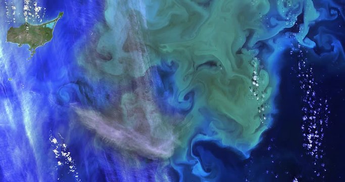 High-altitude overflight aerial of phytoplankton bloom near Alaska's Bering Sea. Clip loops and is reversible. Elements of this image furnished by USGS/NASA Landsat 