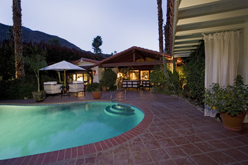 View of swimming pool in front of a modern house against sky
