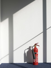 View of a fire extinguisher casting shadow on wall
