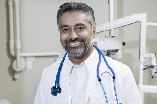 Portrait of a confident male dentist with stethoscope in clinic