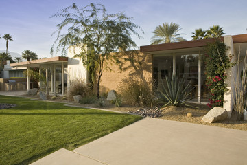 View of modern house exterior with lawn in foreground