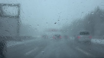 FPV: Dangerous car drive in heavy traffic on highway in bad weather condition