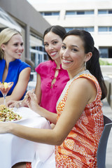 Group of female friends eating out together at a restaurant