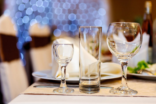 Three glasses on a festive table. Serving at the party. Soft focus, selective focus.