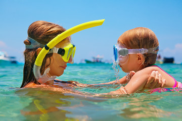 Happy family - mother with baby girl dive underwater with fun in sea pool. Healthy lifestyle,...