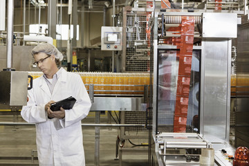 Middle-aged man having inspection at bottling industry