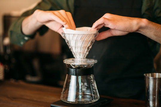 Closeup of male hands  prepares coffee pot