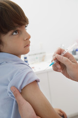 Closeup of boy receiving injection in the clinic