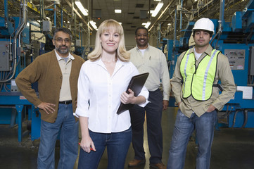 Obraz premium Group portrait of multiethnic operators standing in the factory