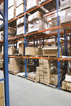 Cardboard boxes on shelves in distribution warehouse