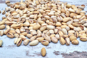 salted pistachios on the old vintage shabby background