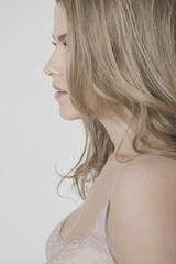 Closeup profile shot of a sexy young woman against gray background