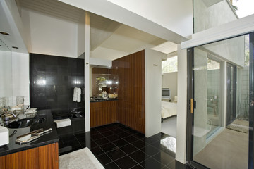 Luxury bathroom with view of bedroom in a modern home