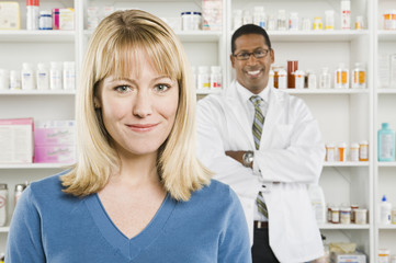 Fototapeta premium Closeup portrait of a pretty woman with pharmacist in the background