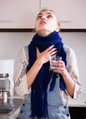  woman in scarf gargling throat with domestic soda
