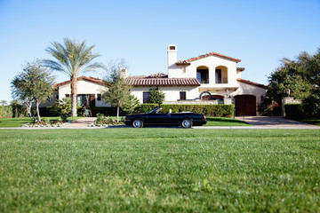 Luxurious car parked outside house in front yard