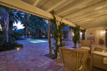 Patio with chairs and table at dusk
